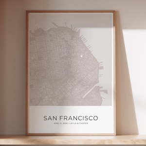 Könnte beinhalten: Ein gerahmter Kartendruck von San Francisco in neutralen Tönen. Der Stadtplan ist detailliert, mit dem Text "SAN FRANCISCO" und dem Datum "APRIL 8, 2026 | LAYLA & CARTER" unten. Der Druck wird auf einem Holzregal angezeigt.