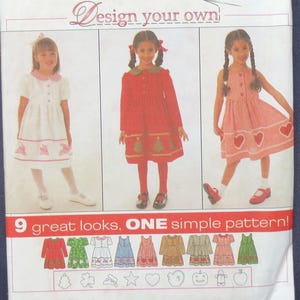 May include: A Simplicity sewing pattern envelope, number 7283, size AA 3,4,5,6. The white package features the text Design your own and 9 great looks, ONE simple pattern! It displays three children wearing dresses with various applique designs.