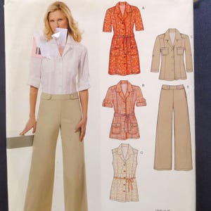 May include: New Look sewing pattern envelope 6615, size A 10-22. The front shows a model wearing a white button-down shirt and tan wide-leg trousers. Illustrations display five garment variations including a belted dress, a jacket, and trousers.