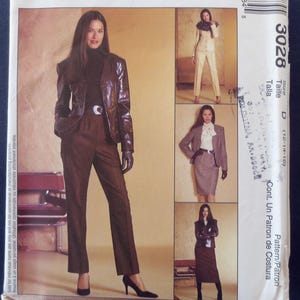 May include: A McCall's sewing pattern envelope featuring a woman in a brown leather jacket and pants. The envelope includes images of different outfit options. Text includes "NON STOP WARDROBE" and "SELECT-A-SIZE".