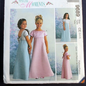 May include: McCall's Special Moments sewing pattern. The pattern features designs for girls' dresses. The main image shows two girls holding hands, each wearing a different style of dress. The dresses are in light blue and pink. The pattern number is 9689.