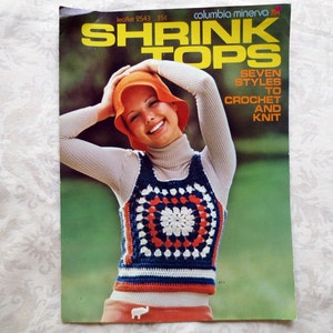 May include: A vintage Columbia Minerva craft leaflet titled SHRINK TOPS, featuring seven styles to crochet and knit. The cover displays a person wearing a multi-colored granny square vest in red, white, and blue, paired with a beige turtleneck.