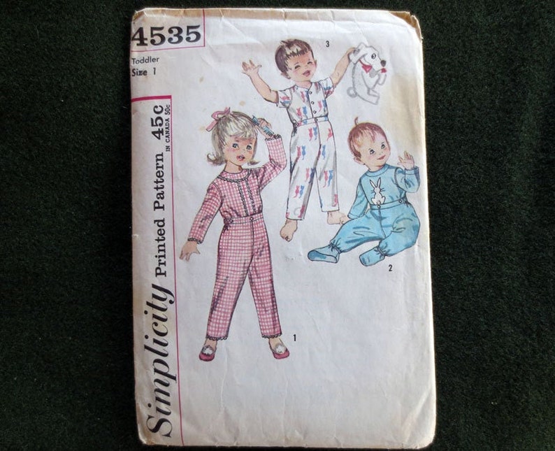 May include: Vintage Simplicity pattern 4535 for toddler pajamas, size 1. The cover features illustrations of children in various pajama styles, including a pink plaid jumpsuit and blue pajamas with a bunny design. Printed Pattern 45c in Canada.