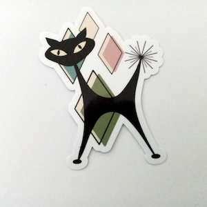 May include: A black cat silhouette with a stylized tail, standing on a background of geometric shapes in shades of green, pink, and white.