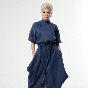 May include: A long, navy blue linen dress with a button-up front, a drawstring waist, and a slightly gathered skirt.