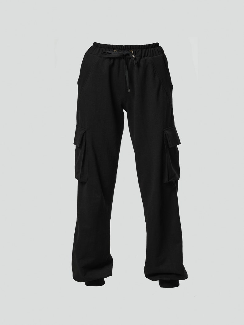 May include: Black cargo pants with a drawstring waist and two large pockets on each leg.