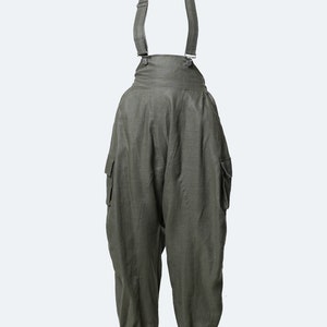 May include: Green linen overalls with adjustable straps and cargo pockets.
