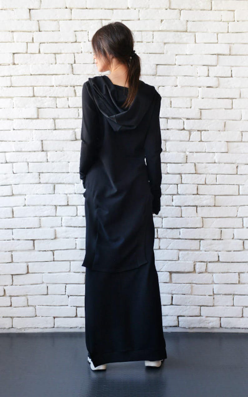 May include: A long black hooded dress with a long skirt and long sleeves. The dress is made of a soft, flowing fabric.