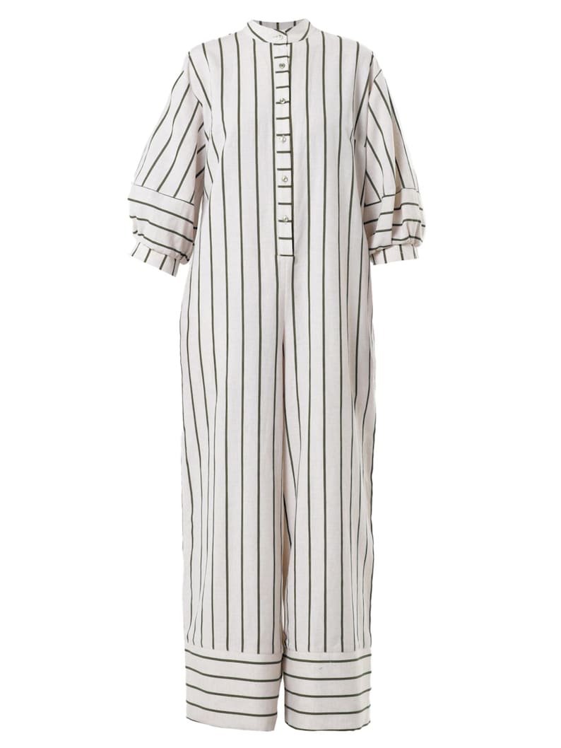 May include: A white and green striped jumpsuit with a button-up front and long sleeves. The jumpsuit has a relaxed fit and a wide leg.