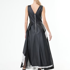 May include: Black sleeveless dress with a white lace trim and a zipper down the back.