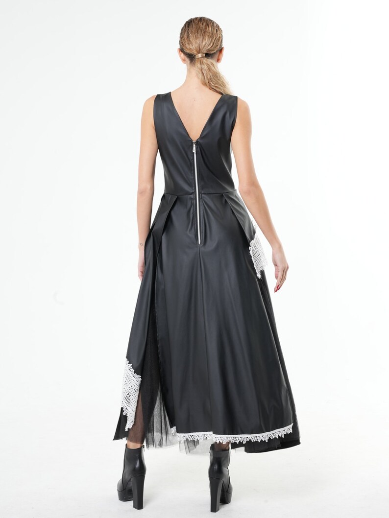 May include: Black sleeveless dress with a white lace trim and a zipper down the back.