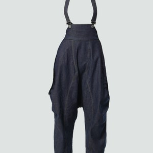 May include: Dark blue denim overalls with adjustable straps and a wide leg silhouette.