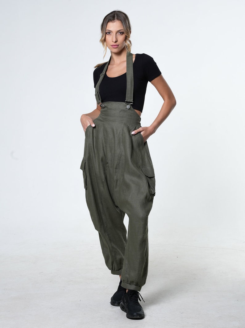 May include: A green linen jumpsuit with wide legs and a relaxed fit. The jumpsuit has adjustable straps and large cargo pockets on the sides.