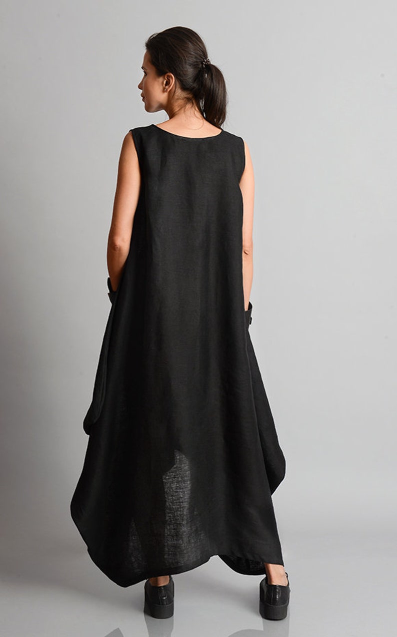 May include: A black sleeveless linen dress with a flowing, asymmetrical hemline. The dress is loose-fitting and has a relaxed, casual style.
