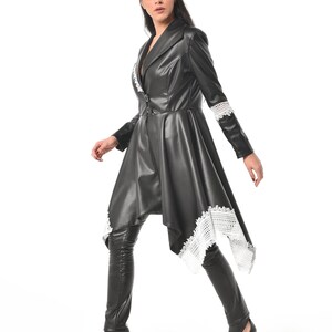 May include: A black leather jacket with a white lace trim. The jacket has a long, asymmetrical hemline and a fitted silhouette.