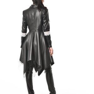 May include: A black leather jacket with a lace trim and a high-low hemline. The jacket has a collar and long sleeves.
