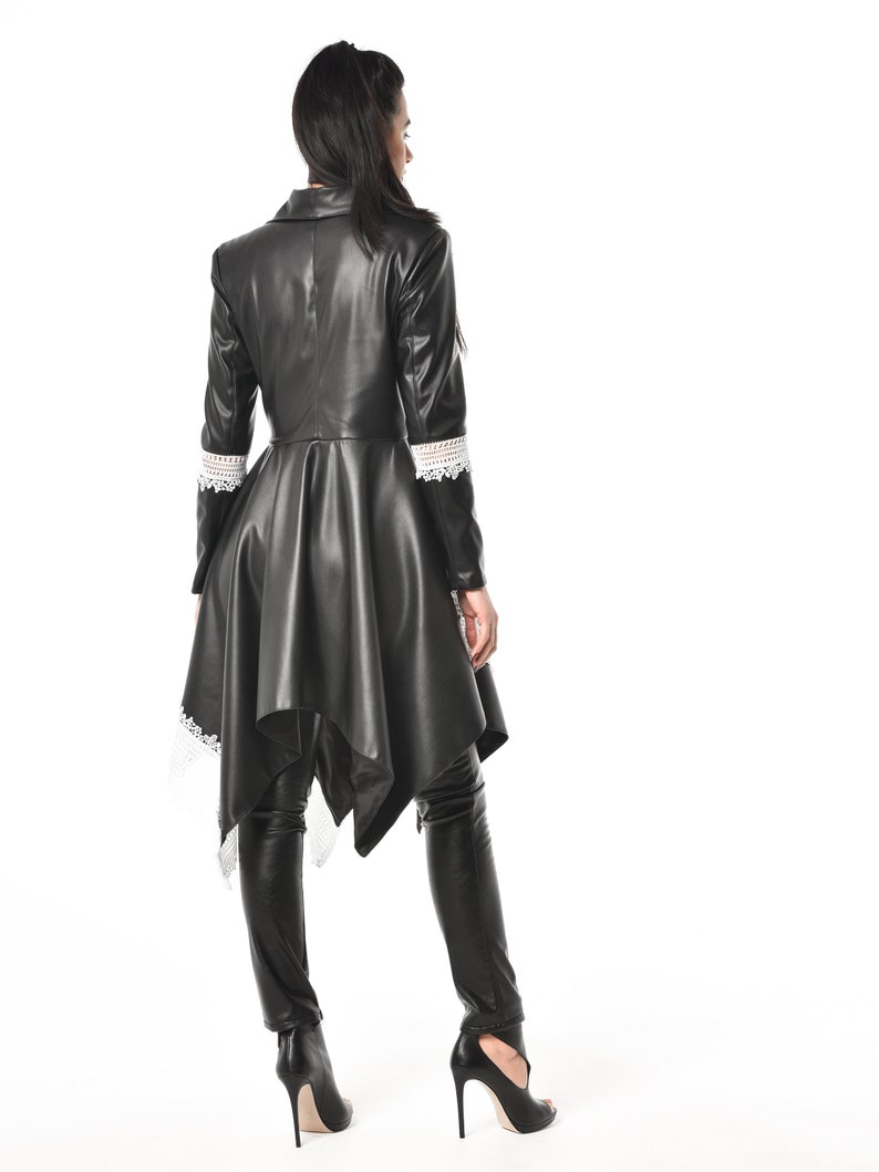 May include: A black leather jacket with a lace trim and a high-low hemline. The jacket has a collar and long sleeves.