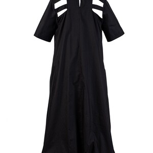 May include: A black midi dress with cutouts at the shoulders and a gathered skirt.