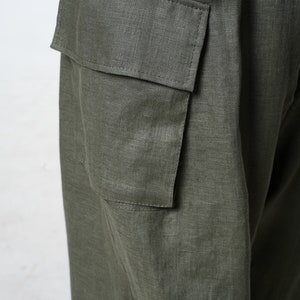 May include: A pair of green linen cargo pants with a large cargo pocket on the side.