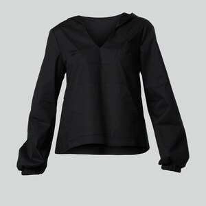May include: A black hooded top with long sleeves and a V-neck. The sleeves have elasticated cuffs. The shirt is made of a plain, solid fabric. The design is casual and comfortable.