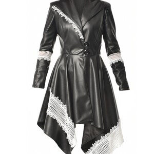 May include: A black faux leather jacket with a white lace trim. The jacket has a long, asymmetrical hemline and a collar.