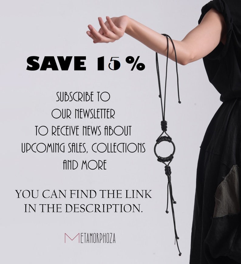 May include: A black leather necklace with a circular pendant and long tassels. The text "SAVE 15%" is displayed above the necklace. The text "SUBSCRIBE TO OUR NEWSLETTER TO RECEIVE NEWS ABOUT UPCOMING SALES, COLLECTIONS AND MORE YOU CAN FIND THE LINK IN THE DESCRIPTION. METAMORPHOZA" is displayed below the necklace.