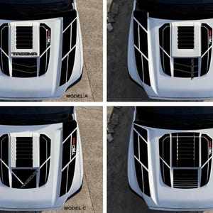 Op de afbeelding: Vier verschillende motorkap stickers voor een Toyota Tacoma pick-up truck. De stickers zijn zwart en wit met rode accenten en bevatten de woorden "TRD PRO" en "TACOMA".