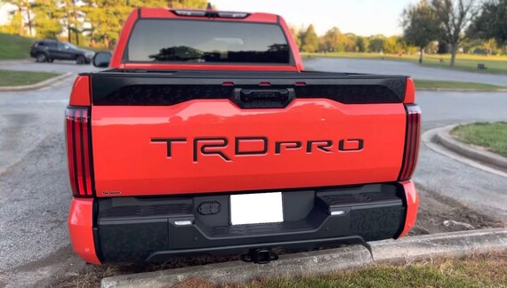 thumbnail image 2 of 2022-2023 Toyota Tundra TRD Pro Tailgate Letters Insert – Black & Red Domed Inlay (Gloss Finish) 2 of 3