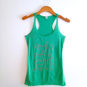 May include: Green tank top with a graphic print of a stack of cats in various poses. The tank top has a racerback style.