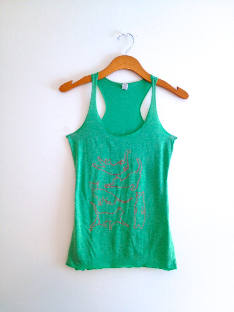 May include: Green tank top with a graphic print of a stack of cats in various poses. The tank top has a racerback style.