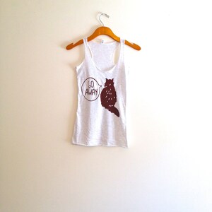 May include: A gray tank top with a brown cat silhouette and the words "Go Away" in a speech bubble.