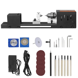May include: A black mini wood lathe with various attachments, including cutting discs, sanding pads, and carving tools. The set includes a power adapter and a variety of small metal tools. Ideal for small woodworking projects.