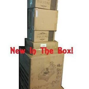May include: A stack of brown cardboard boxes with the word "Inkstar" printed on them. The boxes are stacked on top of each other and the top box has the words "New In The Box!" printed on it.