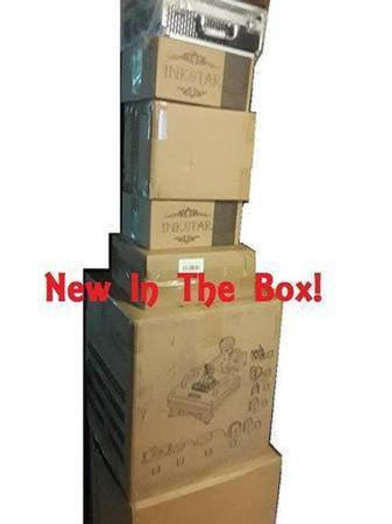 May include: A stack of brown cardboard boxes with the word "Inkstar" printed on them. The boxes are stacked on top of each other and the top box has the words "New In The Box!" printed on it.