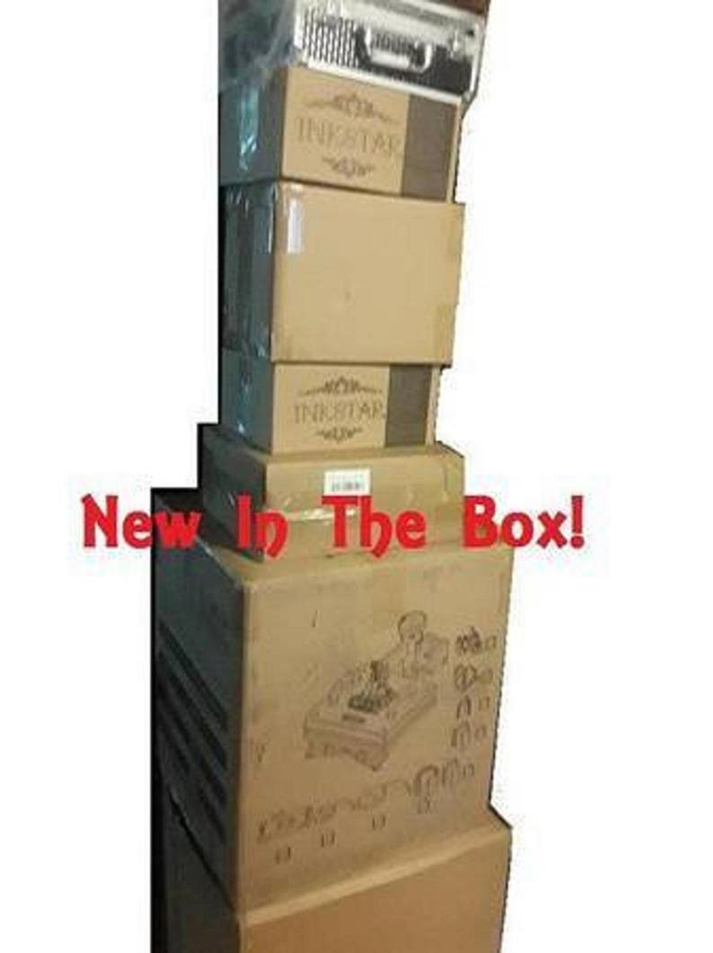 May include: A stack of brown cardboard boxes with the word "INKSTAR" printed on them. The boxes are stacked on top of each other and the top box has a picture of a pinball machine on it. The text "New In The Box!" is printed in red letters on the front of the boxes.