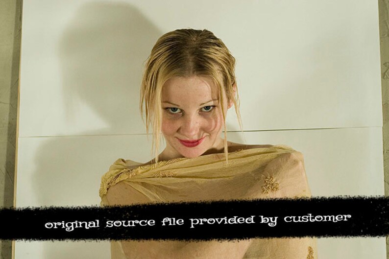 May include: A woman with blonde hair is wearing a sheer gold scarf. She is looking down at the camera with a slight smile.