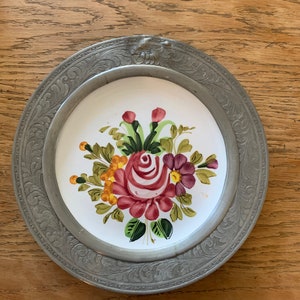 Antique French plate with Pewter rim.  Measures 9”.
