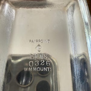May include: A rectangular, silver-colored tray with rounded corners. The tray has the text "PAIRPOINT" at the top, with the logo of a diamond inside a diamond. Below the logo are the letters "E.P.N.S.", the number "0326", and the text "W.M.MOUNTS".