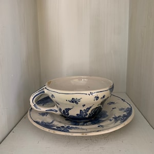 Vintage Blue and White Hand Painted Cup and Saucer.  Measures saucer 6” cup 4.75”.