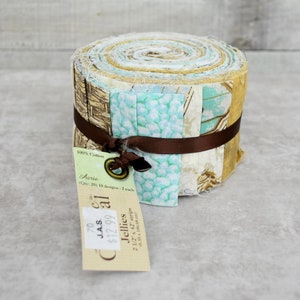 May include: A roll of fabric jelly rolls in a variety of light blue, brown, and beige patterns. The fabric is 100% cotton and is labeled "Aerie" with 20 jelly rolls, 10 designs, and 2 of each design. The label also says "Jellies" and "2 1/2 x 42 strips".