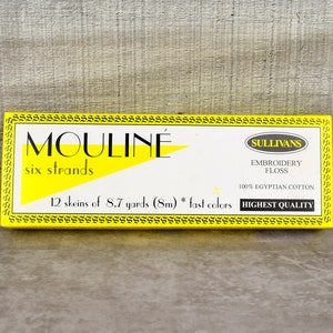 May include: A yellow box of Sullivans Mouline six strands embroidery floss. The box contains 12 skeins of 8.7 yards (8m) of 100% Egyptian cotton in fast colors. The box reads "Highest Quality".