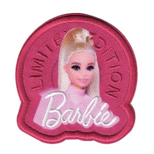 May include: A pink round patch with white stitching. The patch features a cartoon image of a blonde Barbie doll with the text "Limited Edition" and "Barbie" in white.
