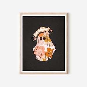 May include: A black and white print of a ghost with a floral pattern in shades of orange and pink. The ghost has the word "bootiful" written above it.