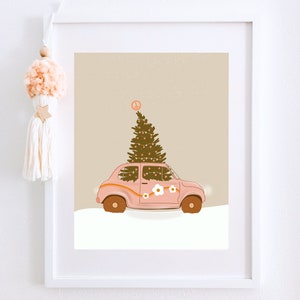 May include: A pink vintage car with a Christmas tree on top, decorated with white flowers and a peace sign. The car is driving through a snowy landscape.