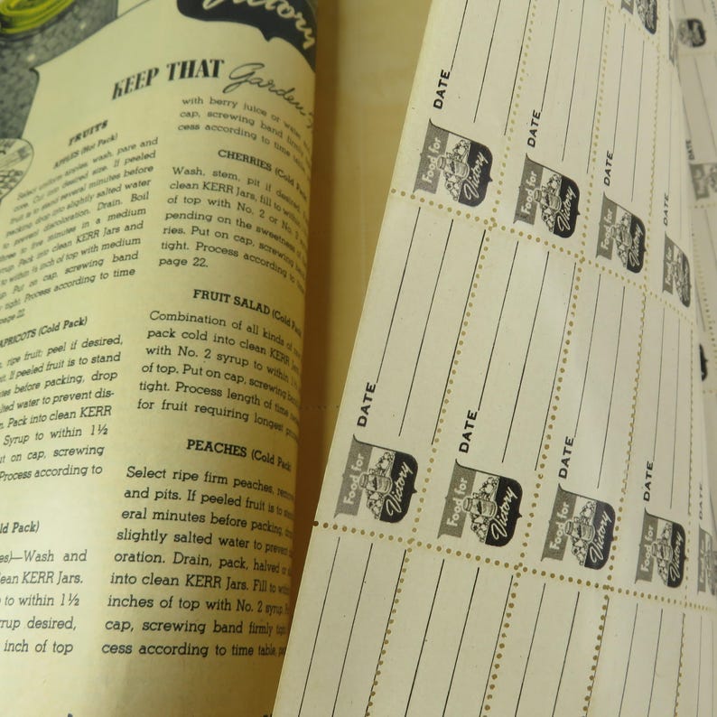 May include: Vintage cookbook pages with instructions for preserving fruits and vegetables. The pages feature text and illustrations, with a focus on canning methods. Includes "Food for Victory" labels for jars.