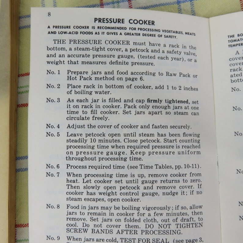 May include: Open book page with instructions for using a pressure cooker. The text is in black font on a white background. The title "PRESSURE COOKER" is at the top, followed by numbered steps for food preparation and canning.