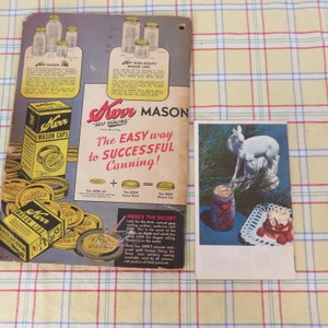 May include: Vintage Kerr Mason jar advertisement and a postcard featuring a white deer statue and a jar of preserves. The advertisement showcases various jar sizes and Kerr Mason Caps. The postcard includes a jar of preserves and a dessert.