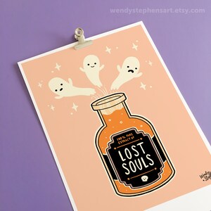 May include: A peach-colored print with three cartoon ghosts flying into a glass bottle filled with orange liquid. The bottle has a black label that reads "100% PURE EXTRACT OF LOST SOULS".
