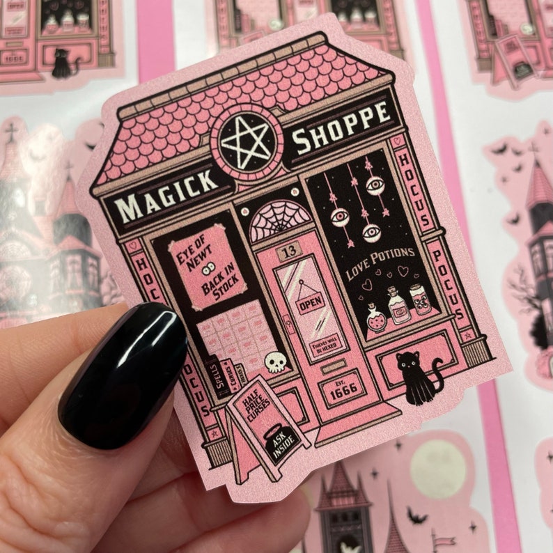 May include: A pink and black storefront with a sign that reads "Magick Shoppe" and a pentagram above the door. The shop windows display various magical items, including love potions, spells, and curses. The shop is open and has a sign that reads "Open".