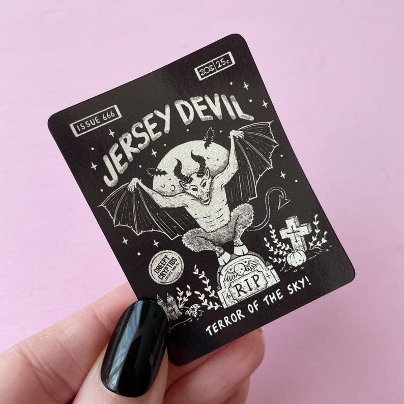 May include: Black and white illustration of the Jersey Devil, a mythical creature with wings and a goat-like head, on a black background. The illustration is titled "Jersey Devil" and includes the text "Issue 666" and "Terror of the Sky!"